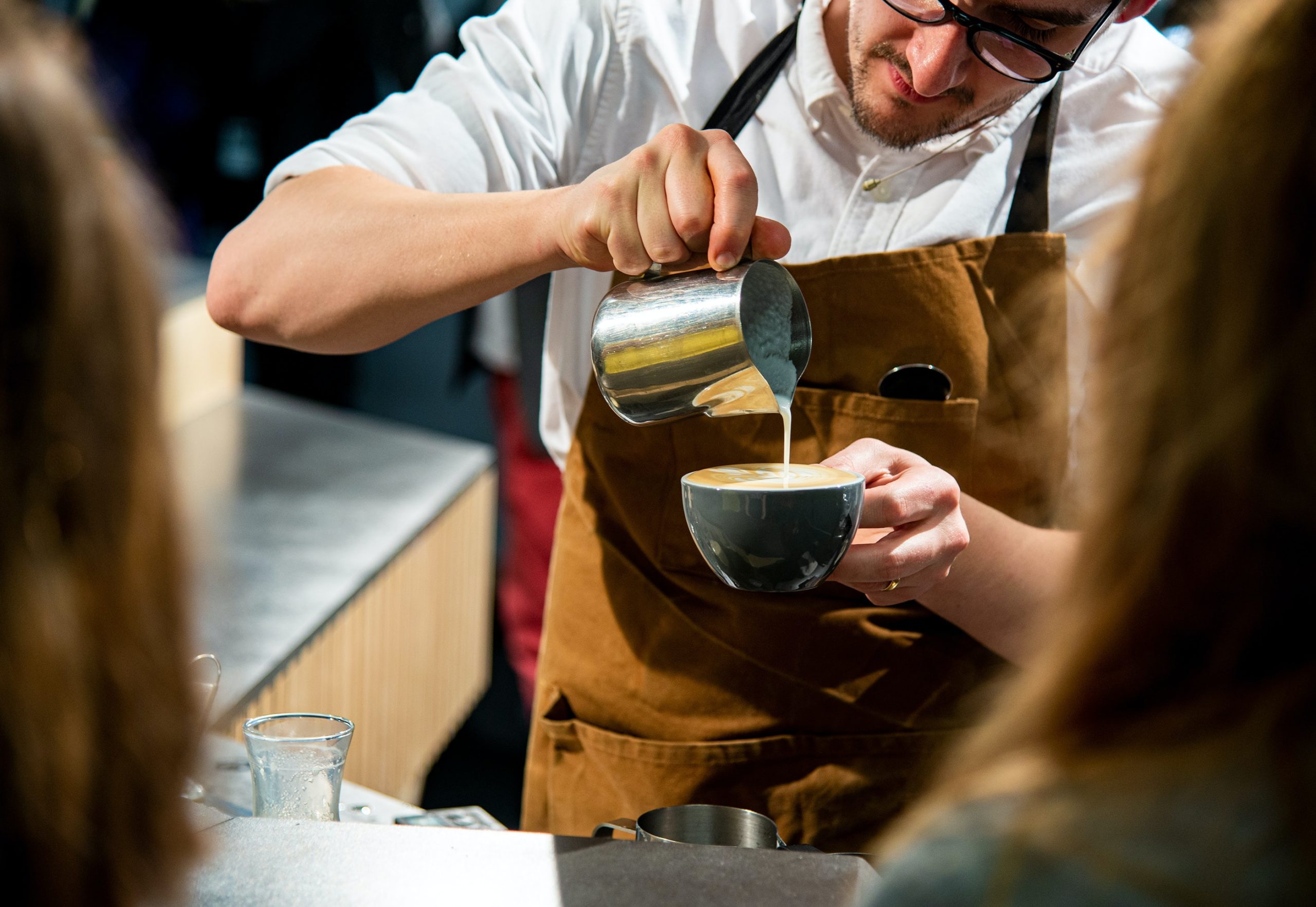 barista pouring latte art