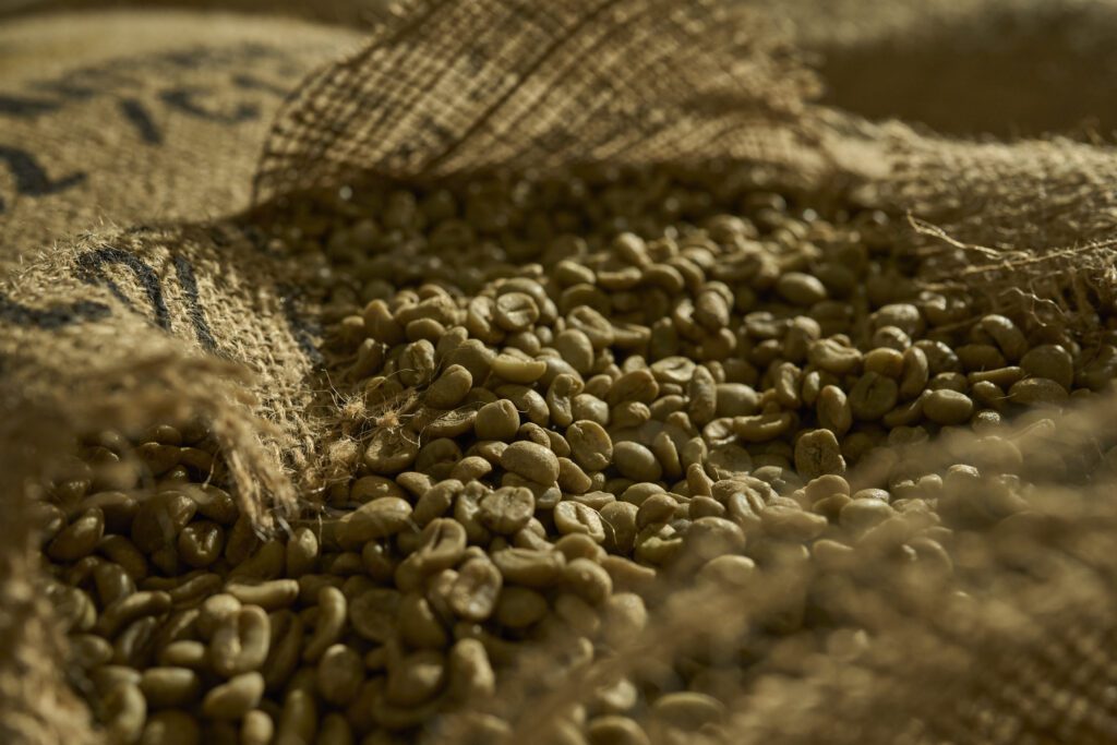 A opened hessian sack of green beans ready for roasting