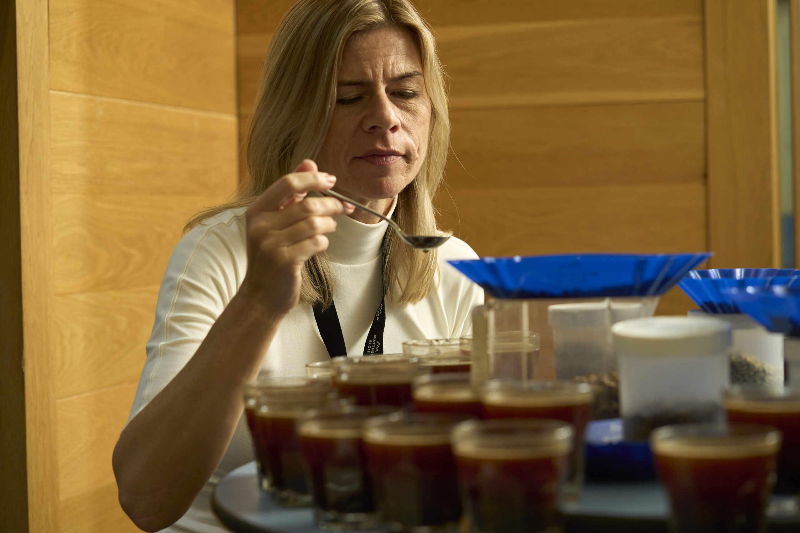 Coffee expert doing a coffee cupping to test the quality of the freshly roasted coffee beans