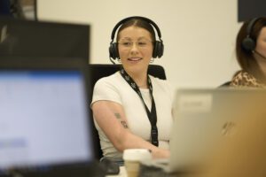 Customer service staff member with phone headset helping to take a customer order
