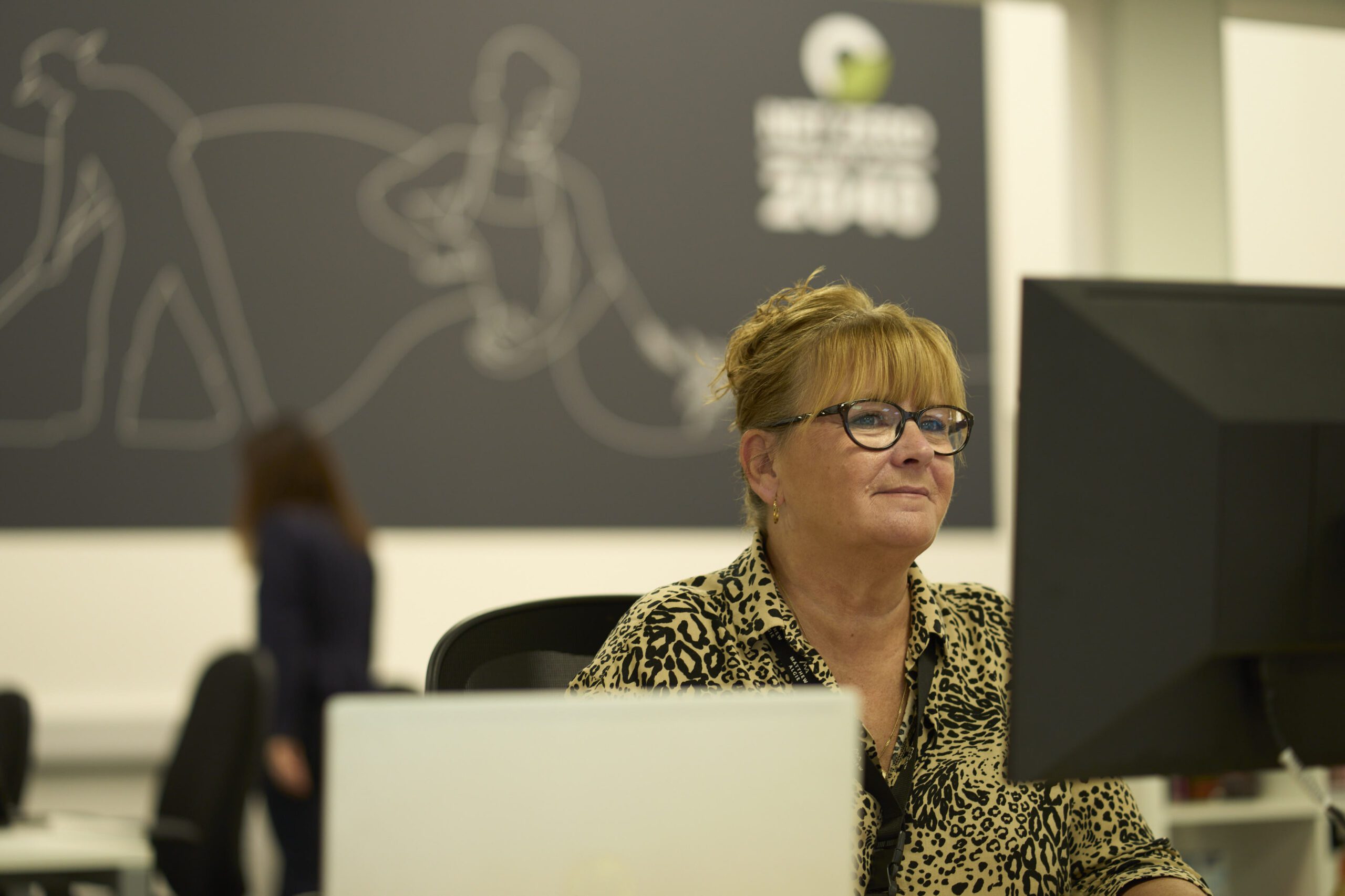 Customer service staff working on computer in call centre