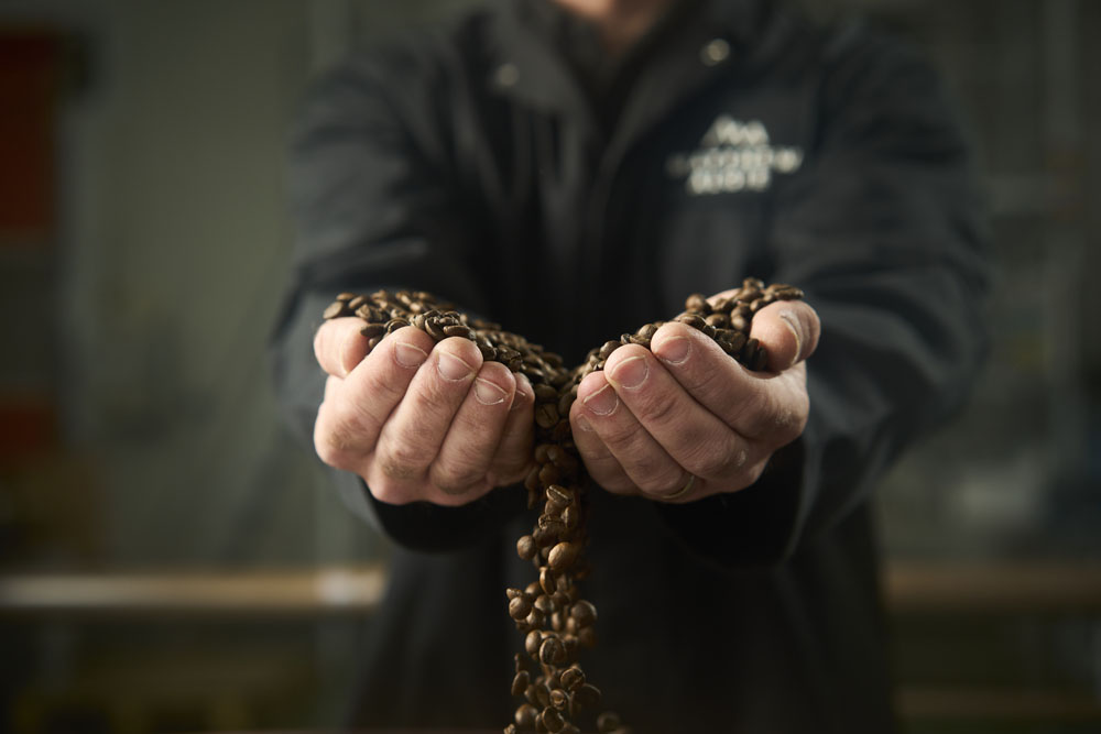 Matthew Algie Coffee master and roaster inspecting roasted coffee