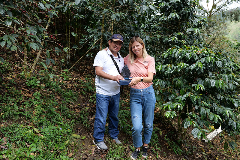 Matthew Algie team member standing with coffee farmer in Peru