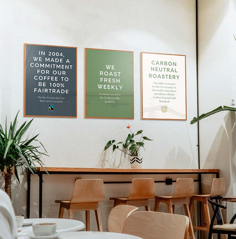 Cafe setting with three posters on the wall.