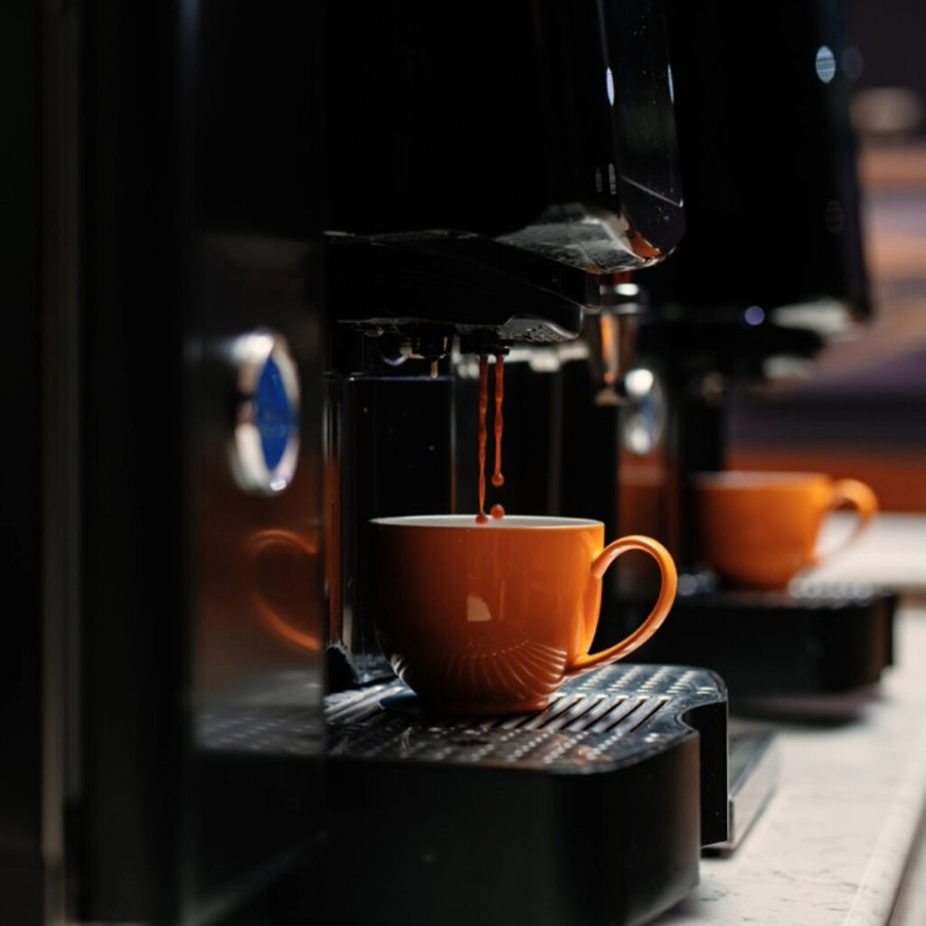 Coffee pour from an automatic bean to cup Carimali coffee machines.